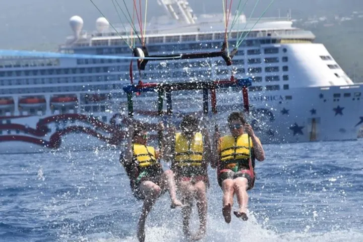 a man riding on the back of a boat in the water