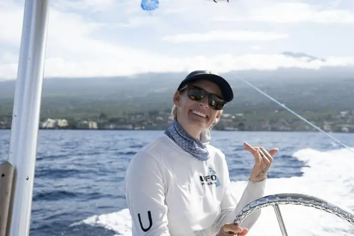 a person riding on the back of a boat in a body of water
