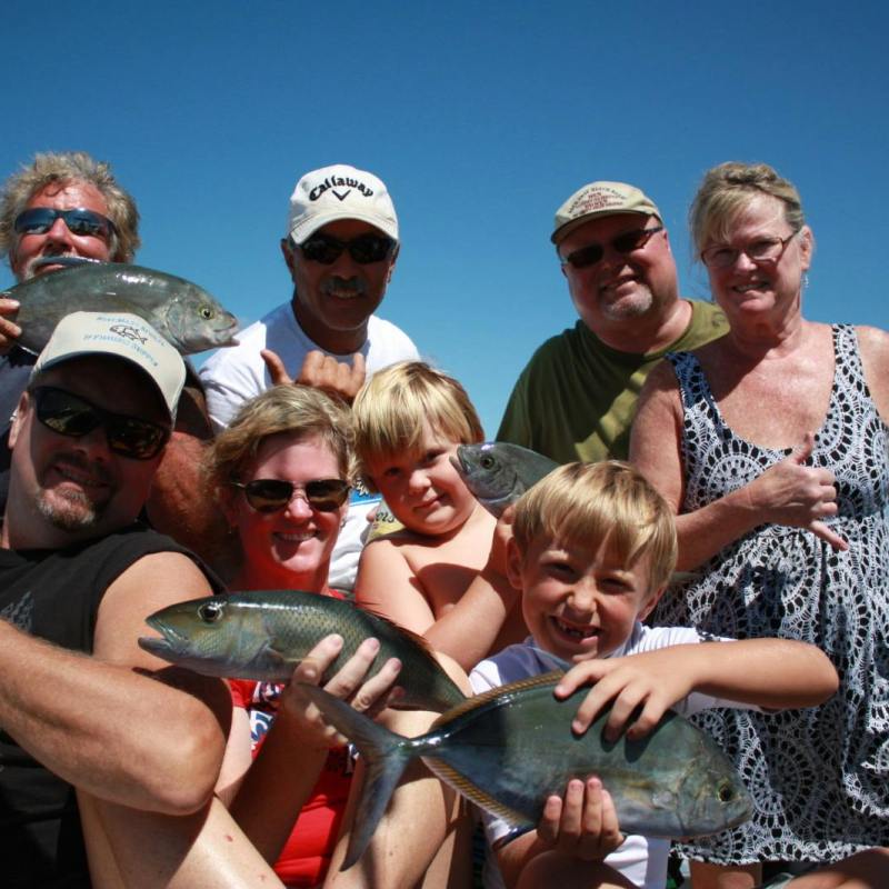 a group of people looking at a cell phone