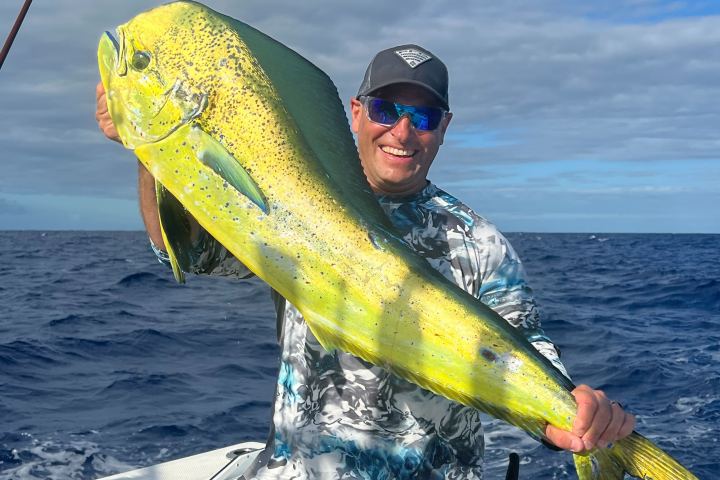 a man carrying a surf board in the water