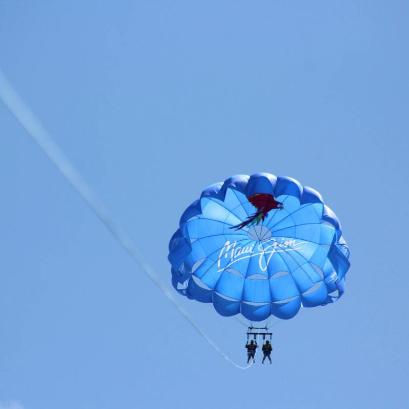 a parachute is flying through the clear blue sky