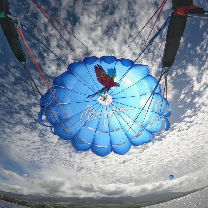 a blue and white kite flying high in the air