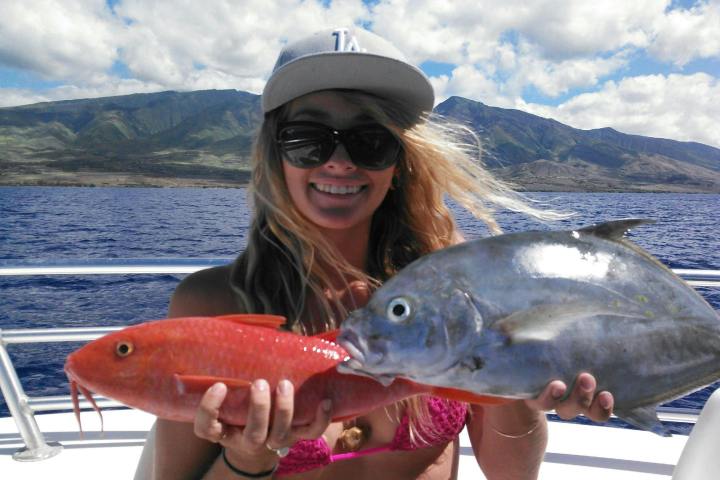 a person holding a fish in the water