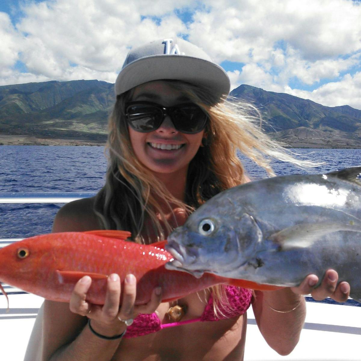 a person holding a fish in the water