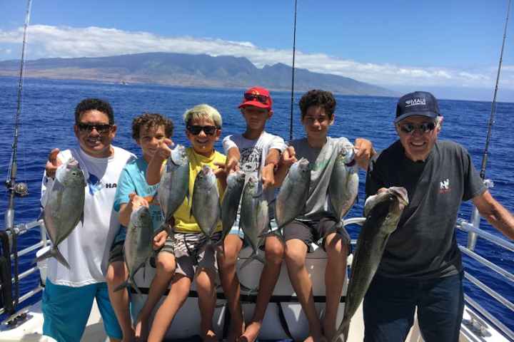 a group of people standing next to a body of water