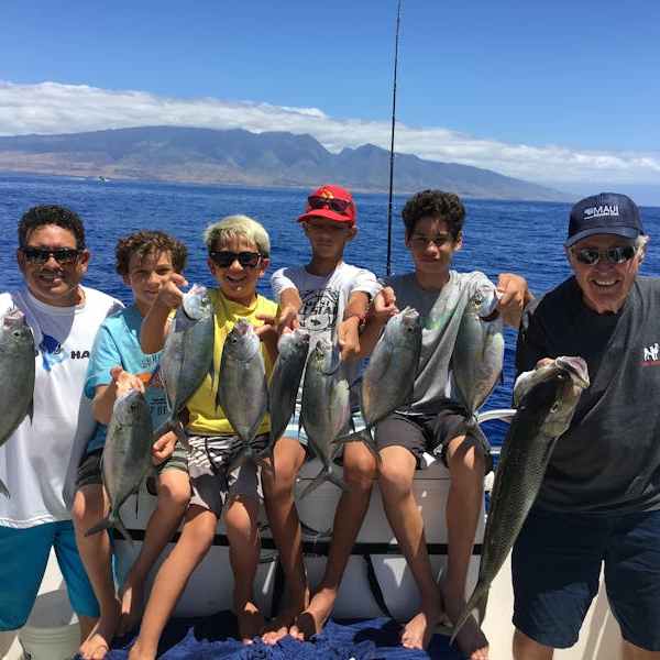 a group of people standing next to a body of water