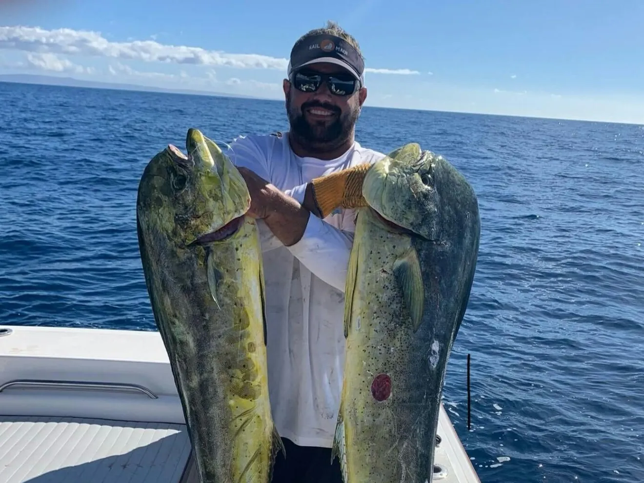 a man holding a fish in the water