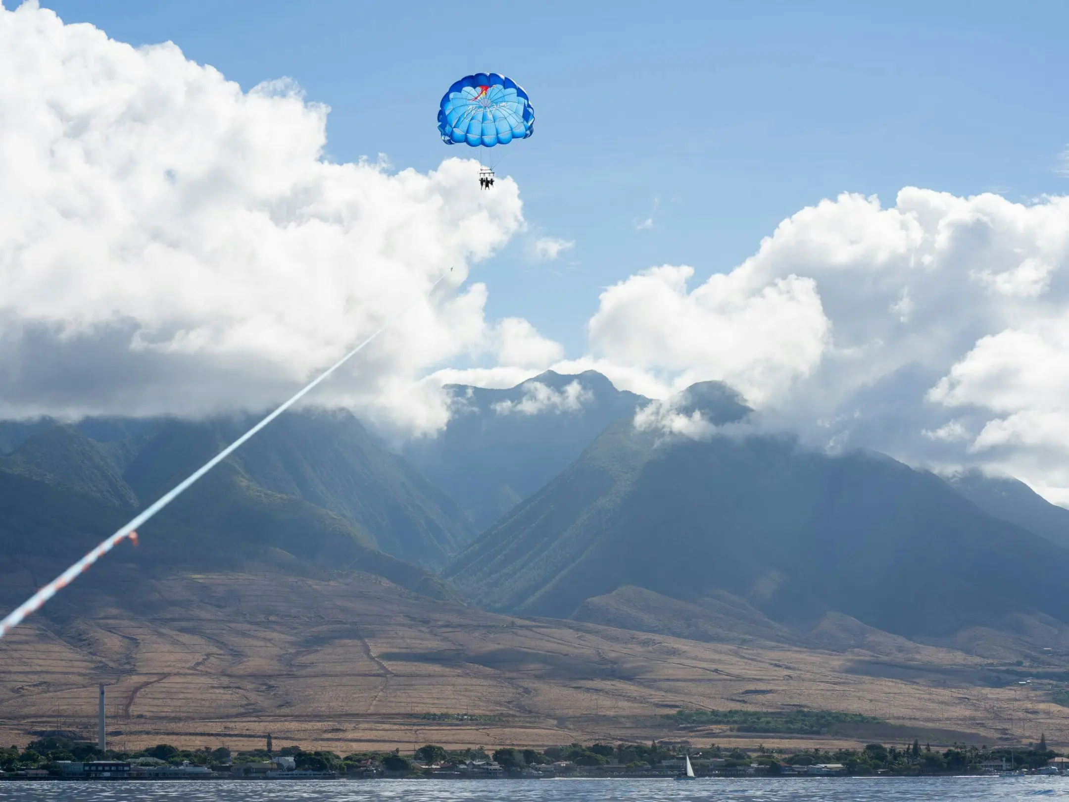 a person flying a kite in a large body of water