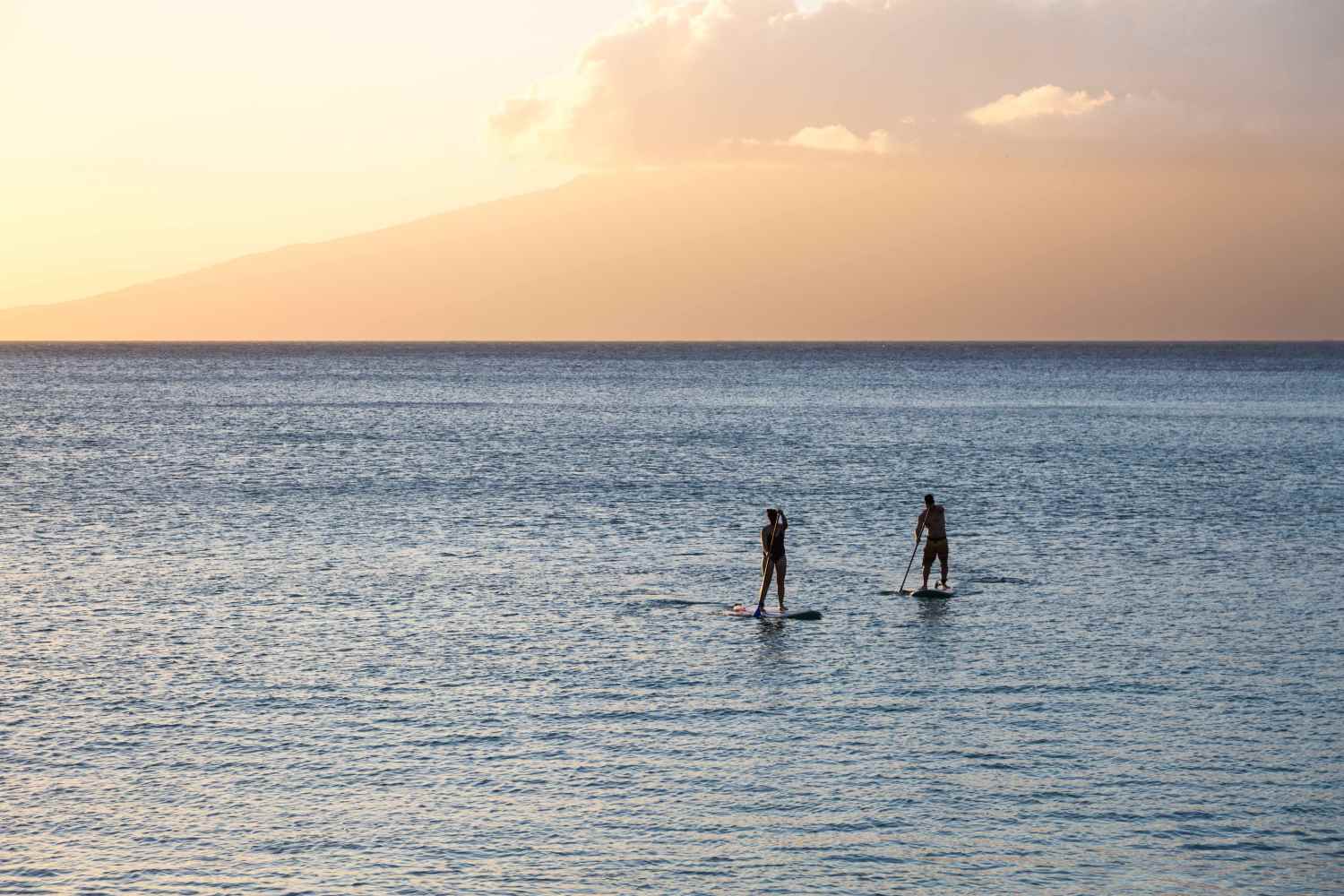 a man standing next to a body of water