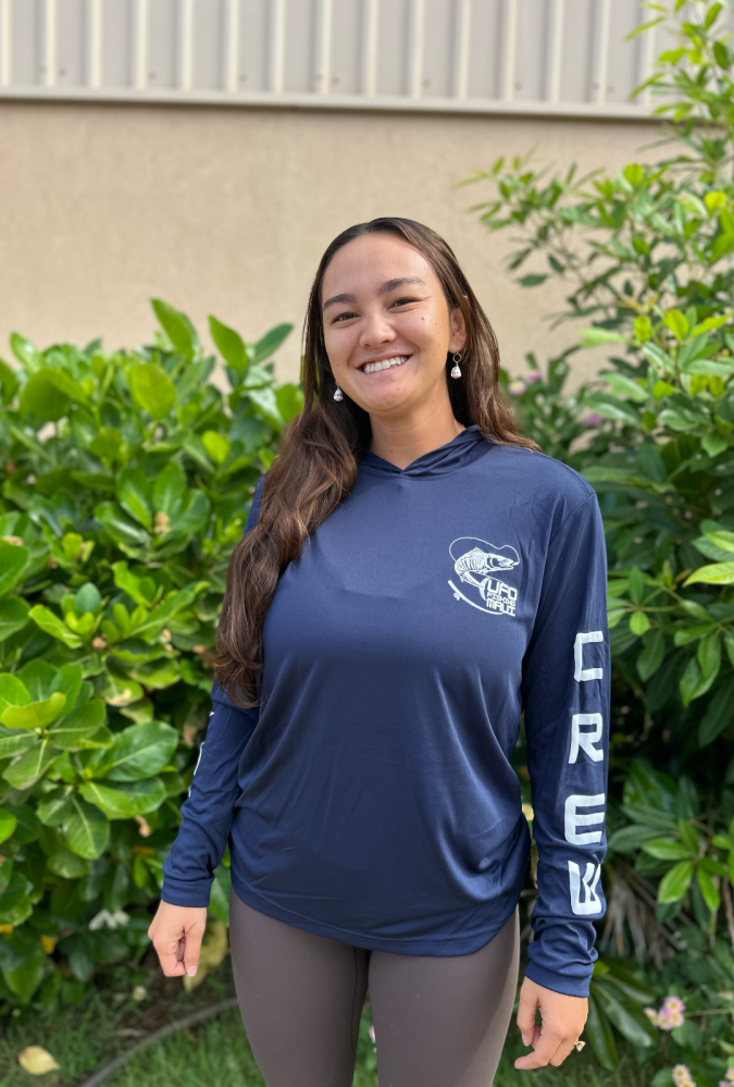 a man standing on top of a grass covered field